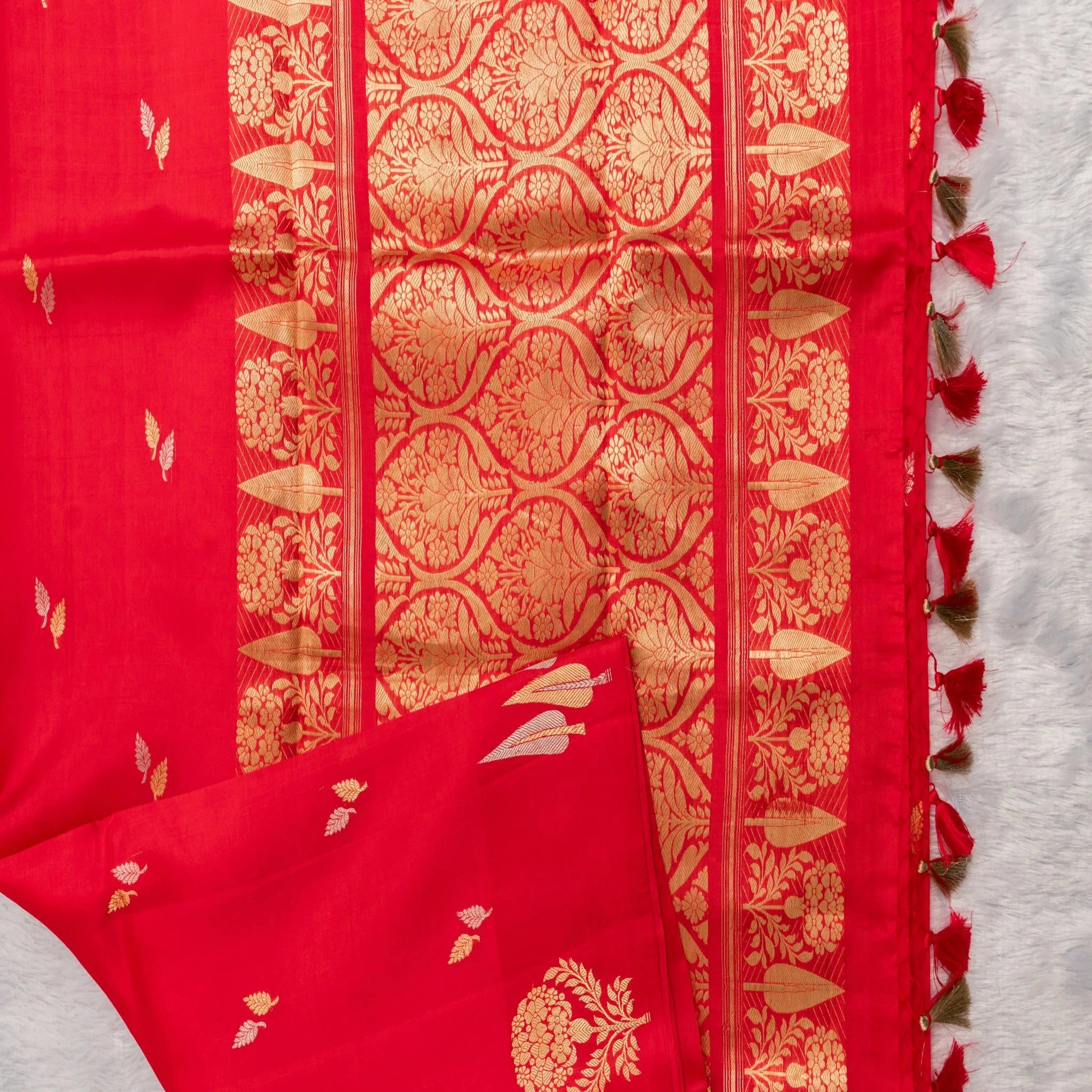 Red fabric with gold patterns on a white background