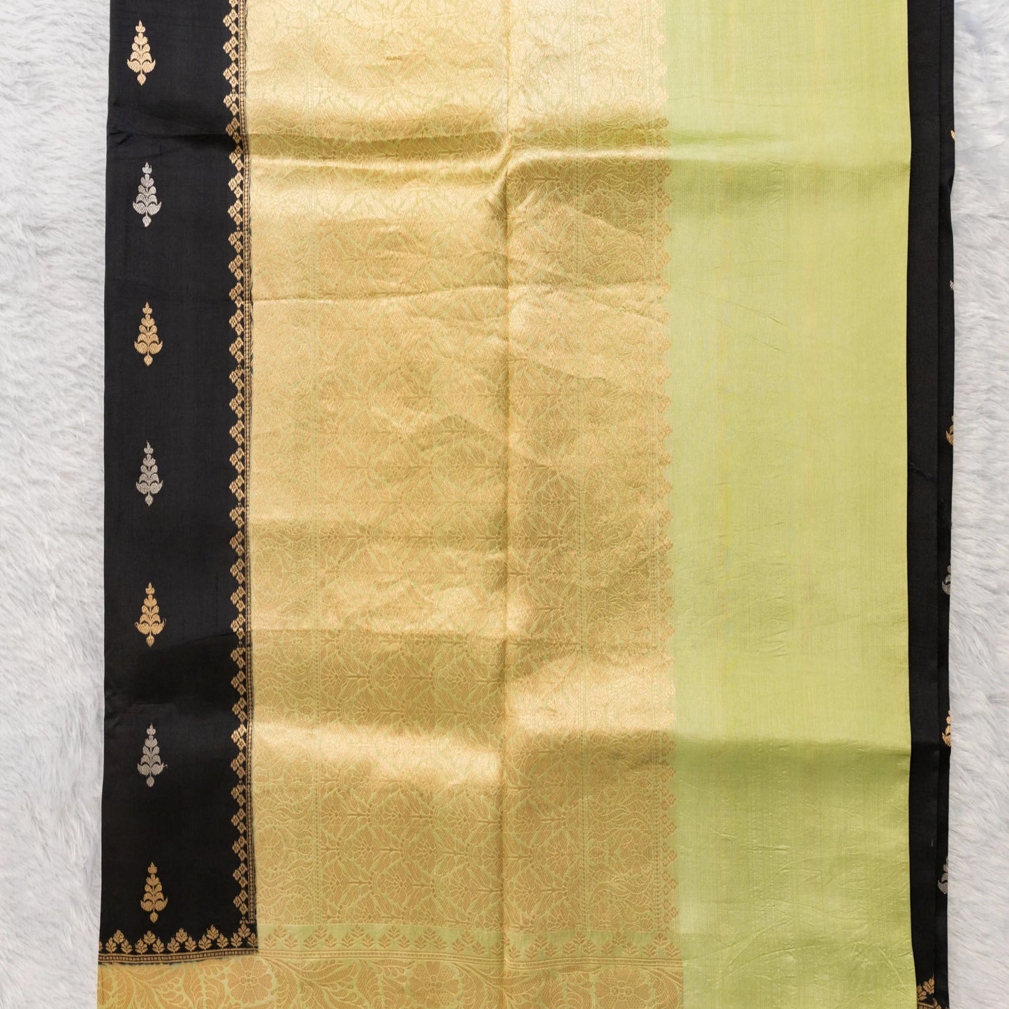 Traditional saree with a black border on a white background