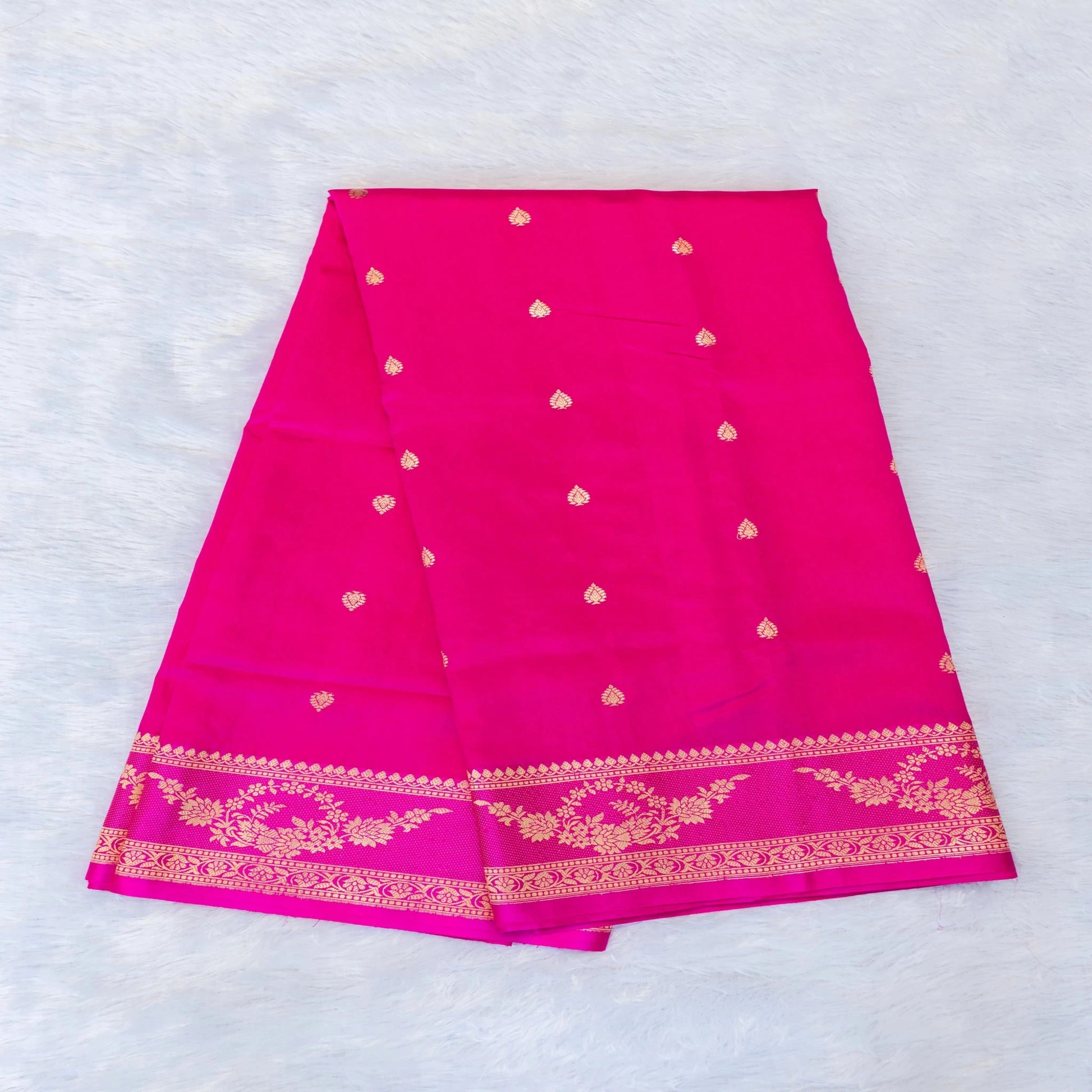 Pink saree with gold patterns on a white background