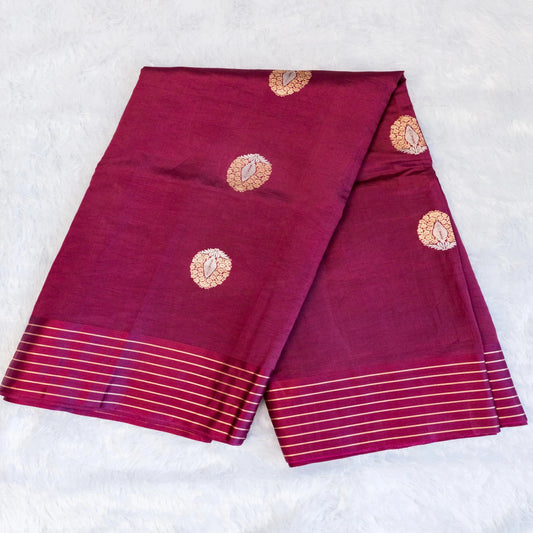 Two maroon sarees with gold patterns on a white background