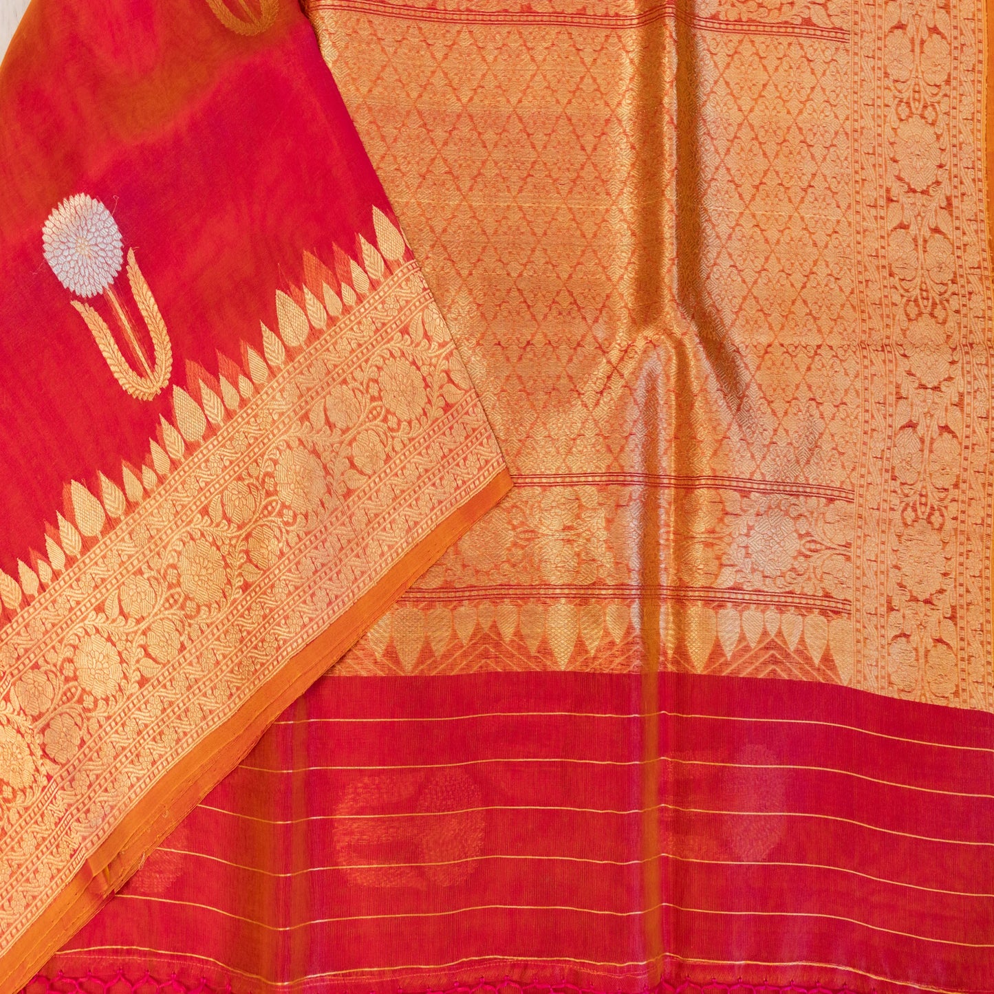 Red and orange saree with intricate patterns