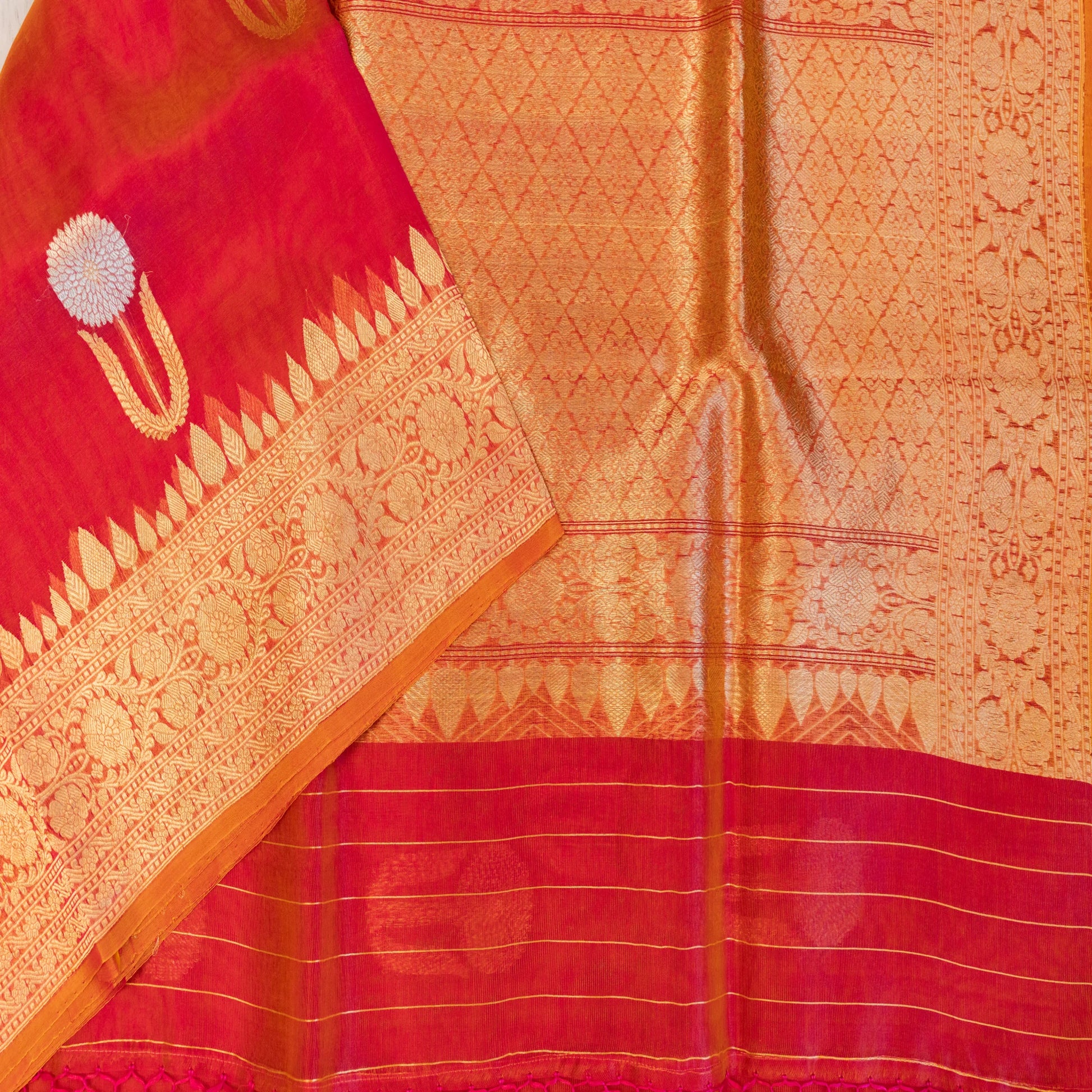 Red and orange saree with intricate patterns