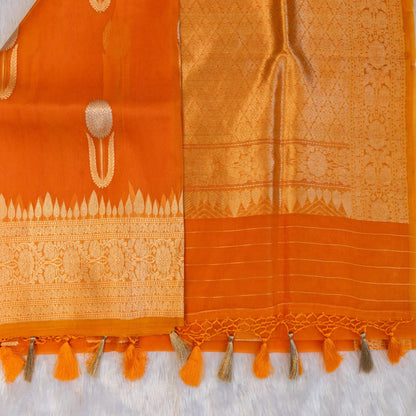 Orange saree with intricate patterns and tassels on a white background