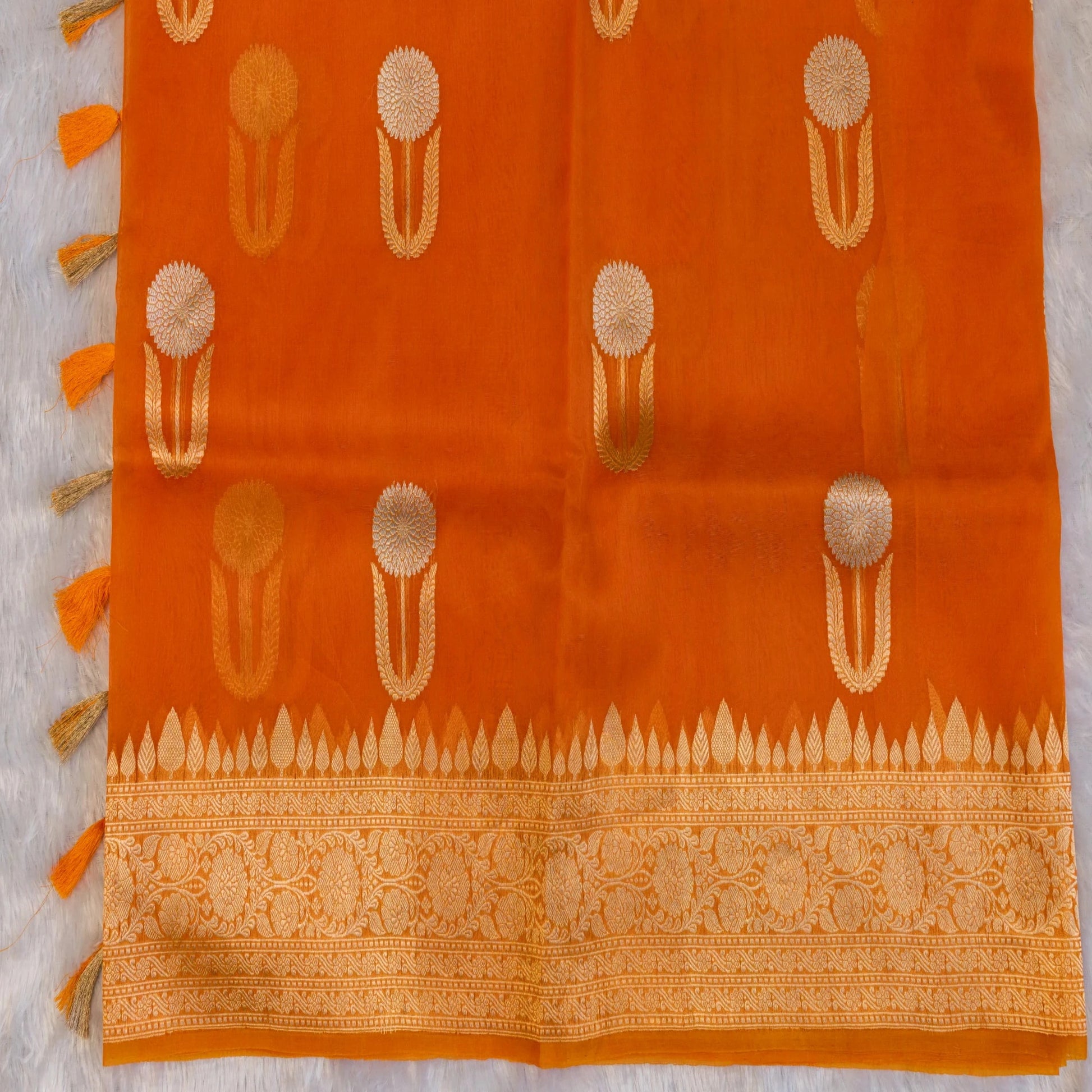 Orange fabric with gold patterns on a white background