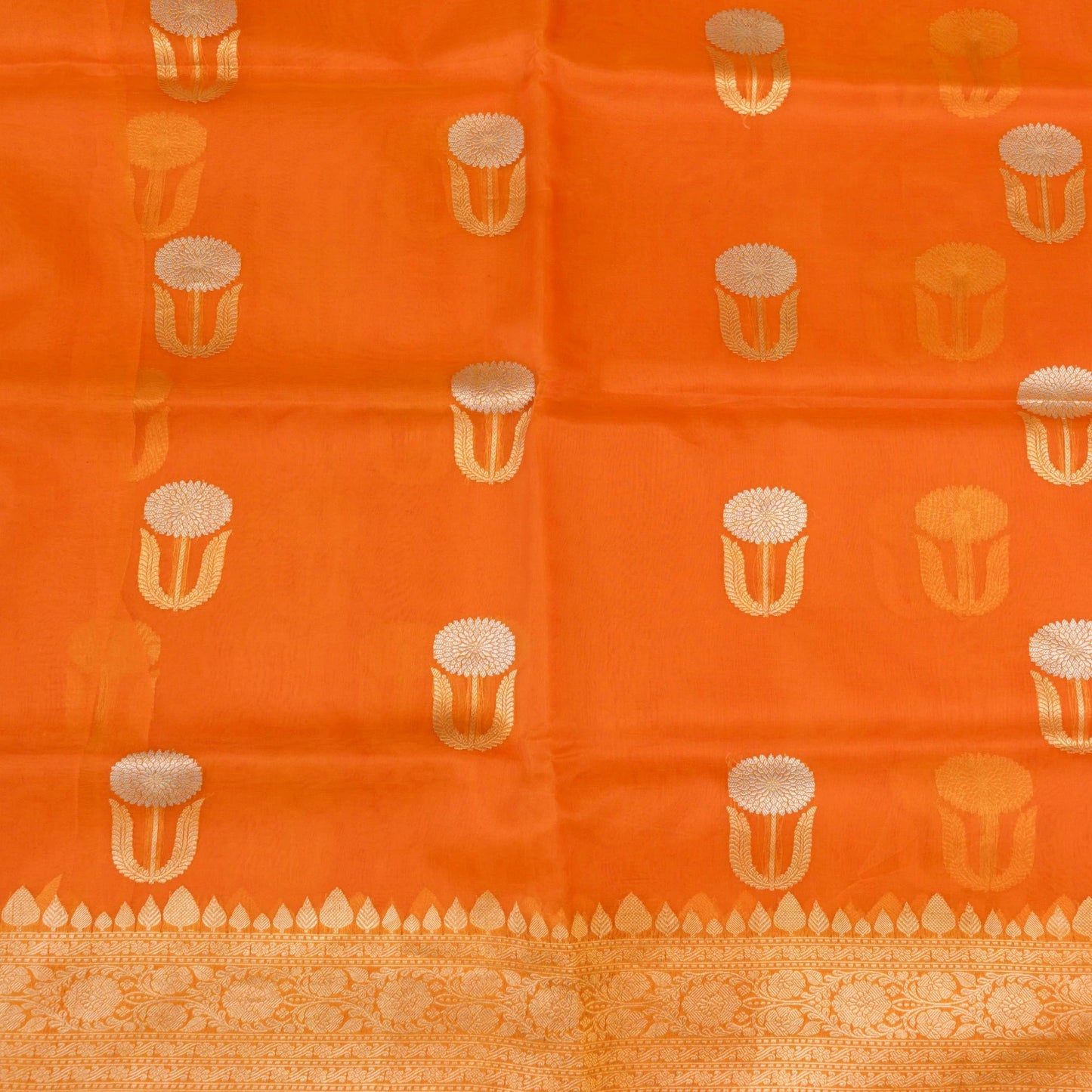 Orange fabric with gold and white pattern