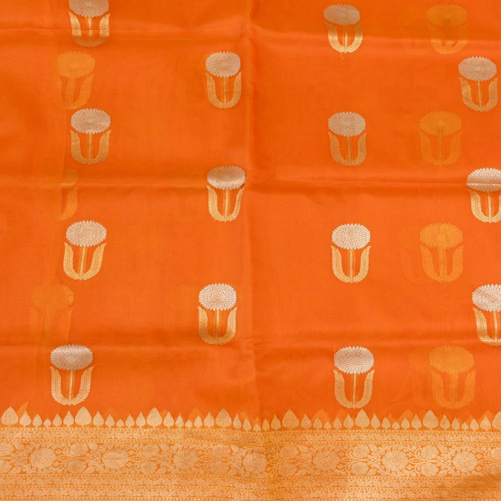 Orange fabric with gold and white pattern