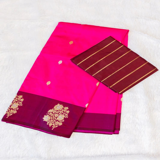 Pink saree with gold embroidery on a white background
