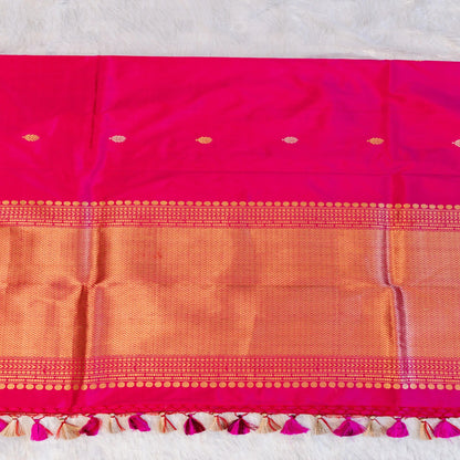 Pink and orange saree with decorative border on a light gray background