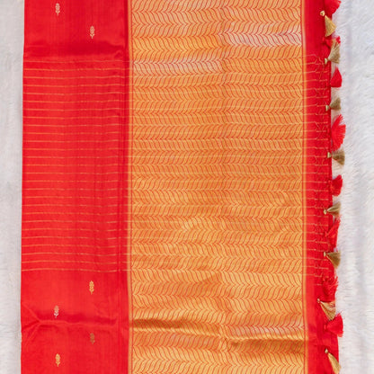 Red and orange saree with decorative border on a white background