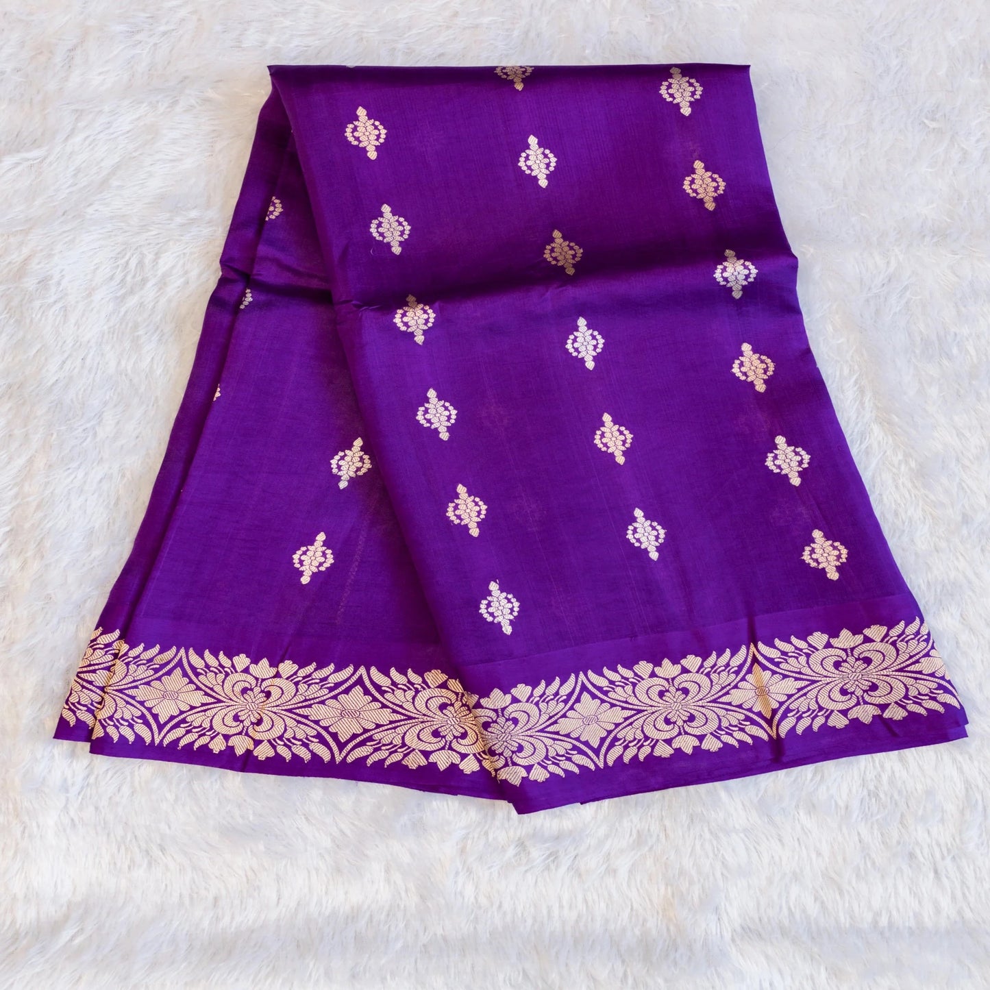 Purple fabric with gold patterns on a white background