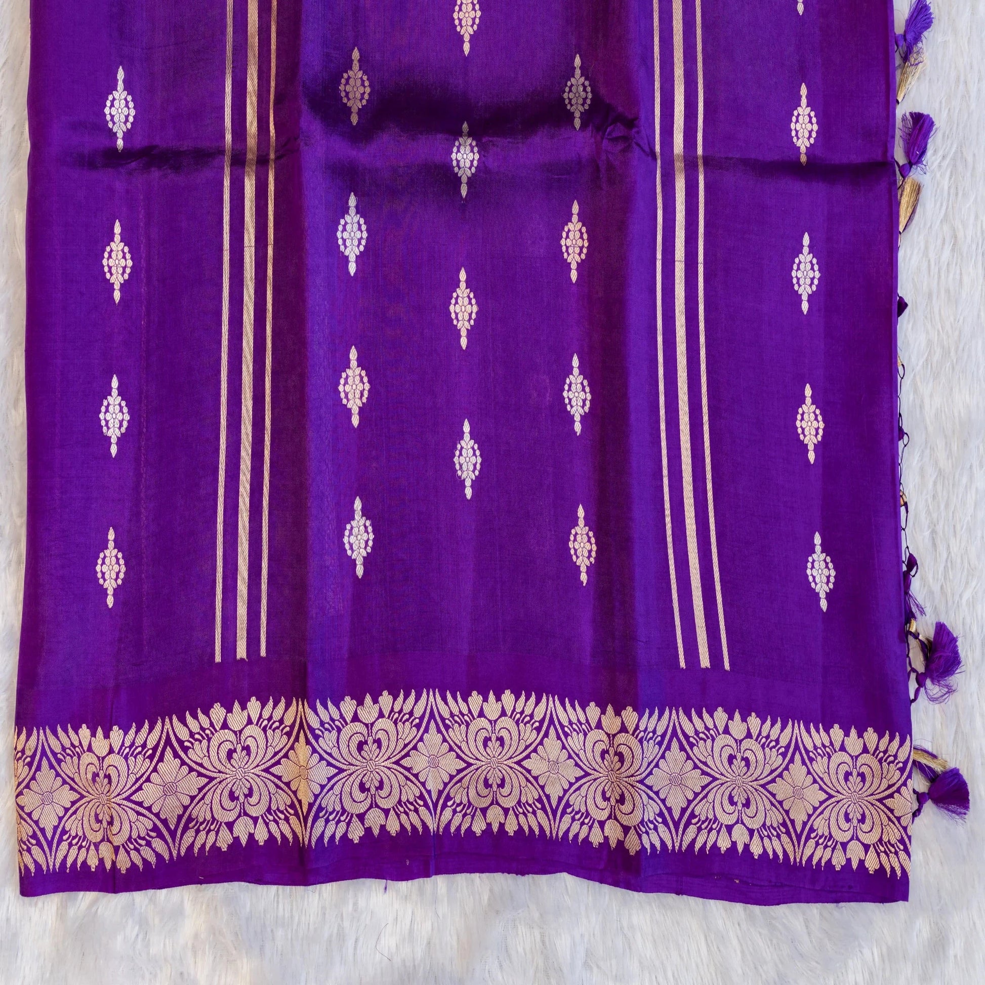 Purple fabric with gold and white patterns on a white background