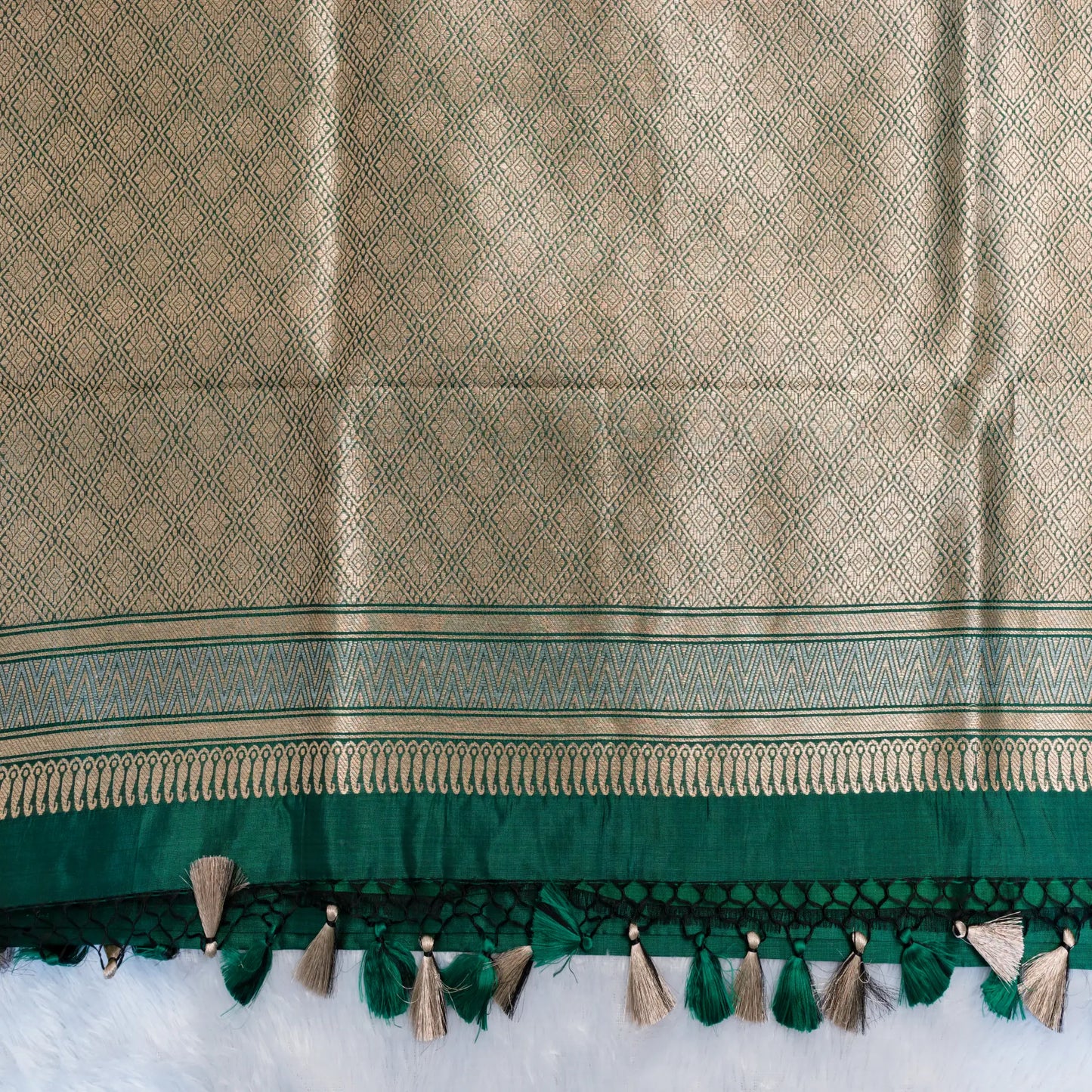 Textured fabric with green and beige pattern on a white background