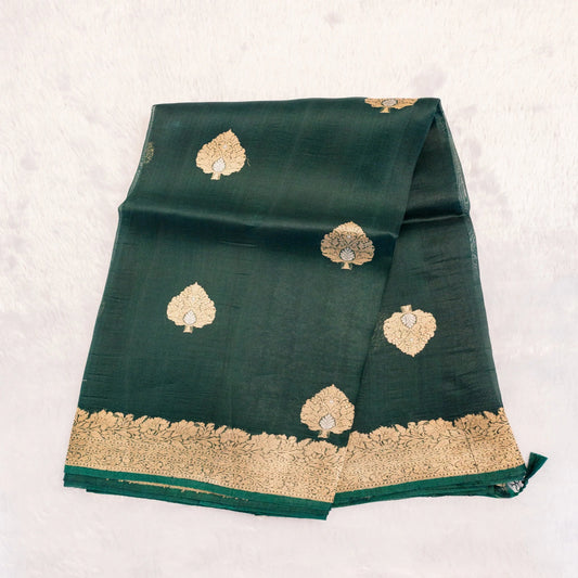 Green fabric with gold embroidery on a white background