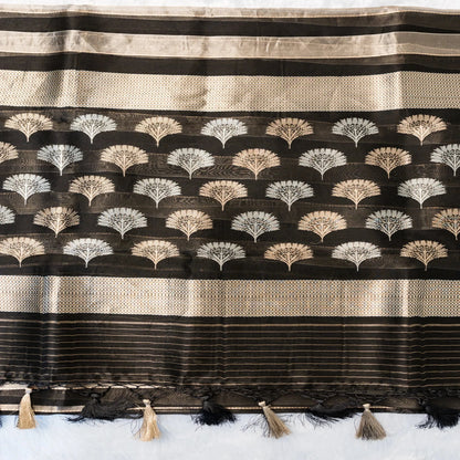 Black and beige striped fabric with decorative patterns and tassels on a white background