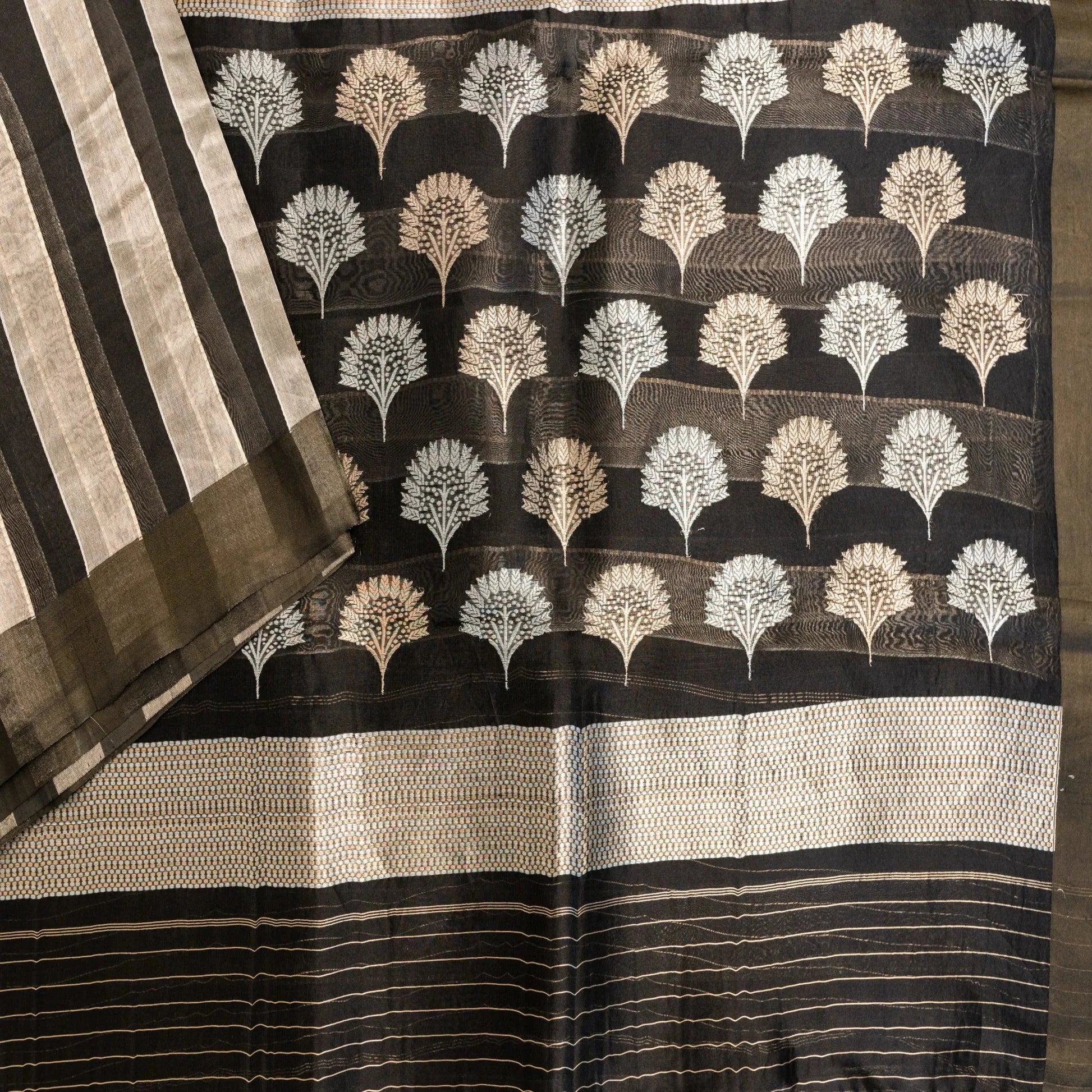 Black saree with white leaf pattern and gold border