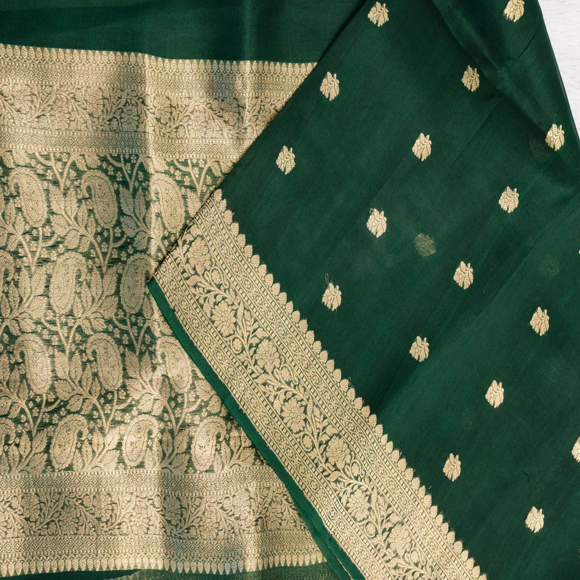 Green fabric with gold embroidery and patterns