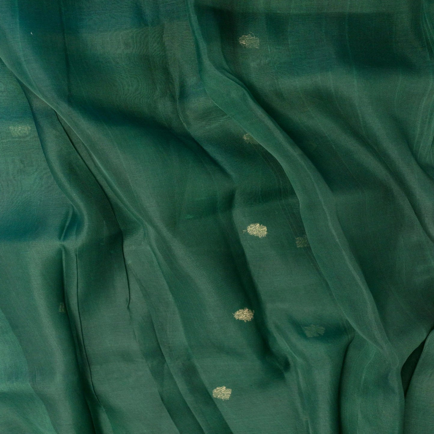 Close-up of teal fabric with subtle patterns