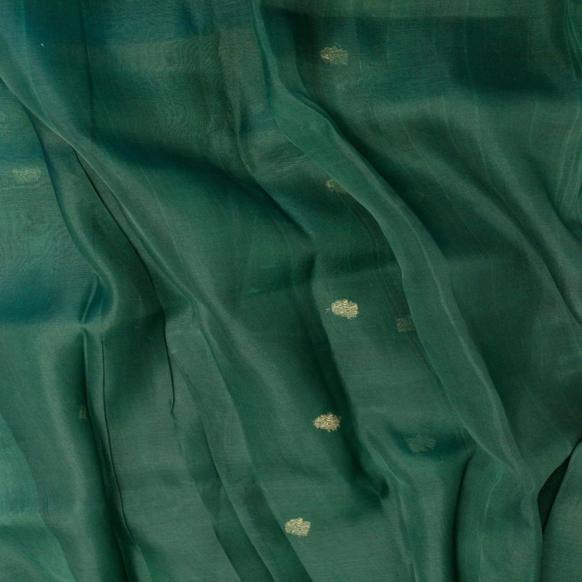 Close-up of teal fabric with subtle patterns