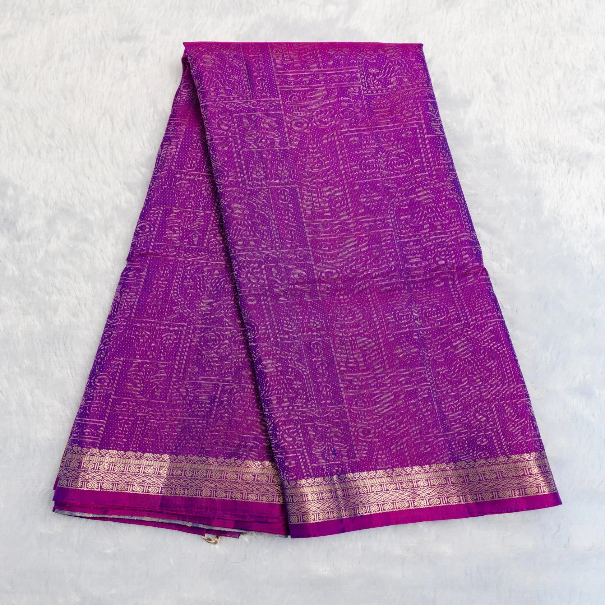 Purple saree with gold border on a white background