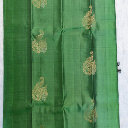 Green fabric with gold embroidery on a white background