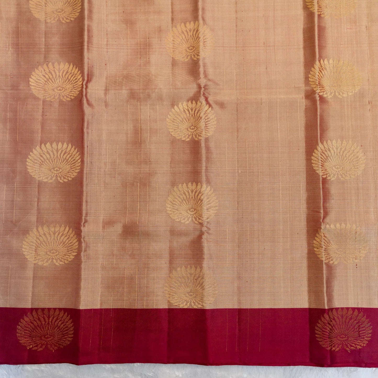 Saree with gold floral patterns on a brown and red background