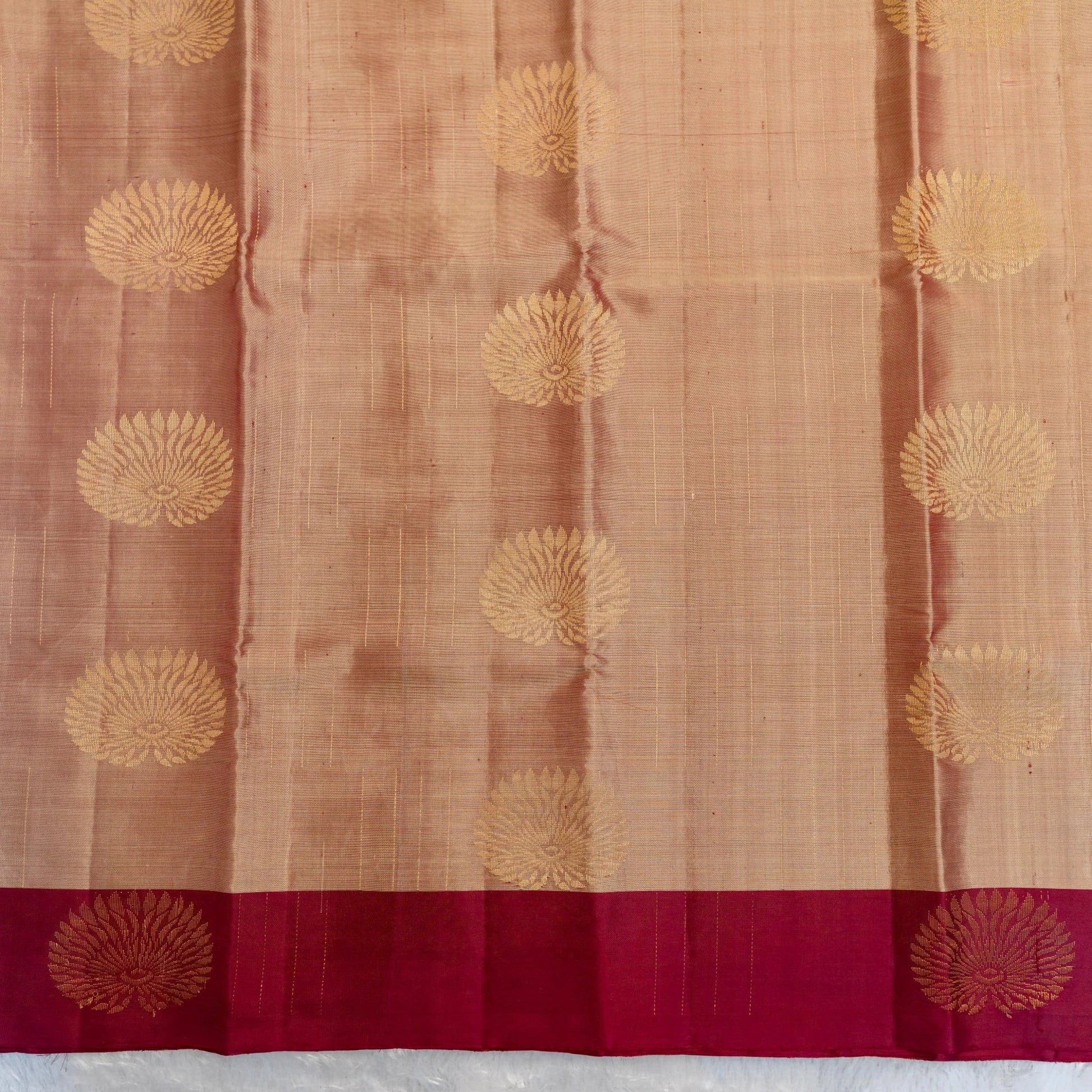 Saree with gold floral patterns on a brown and red background