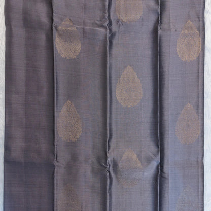 Dark gray fabric with gold circular patterns on a light gray background