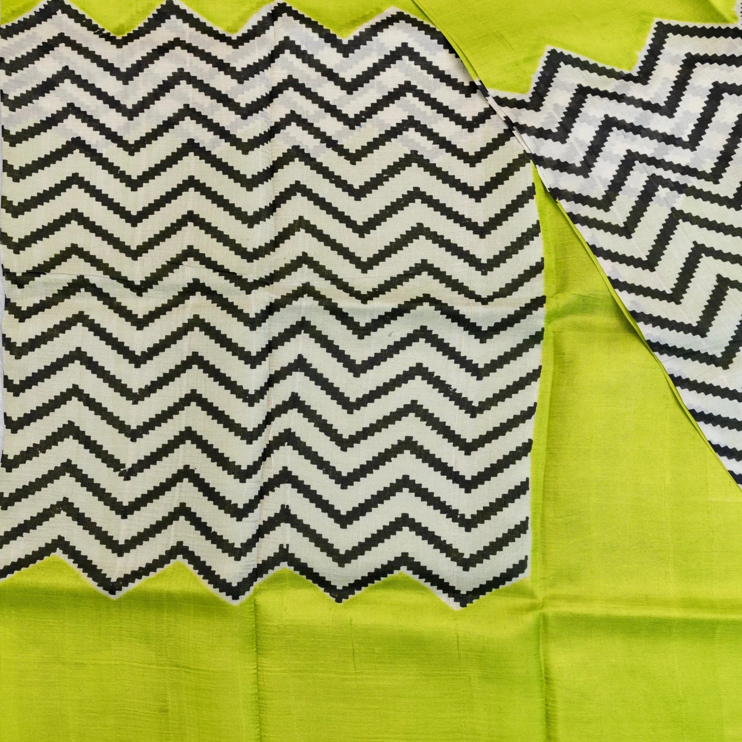Fabric with a zigzag pattern on a green background