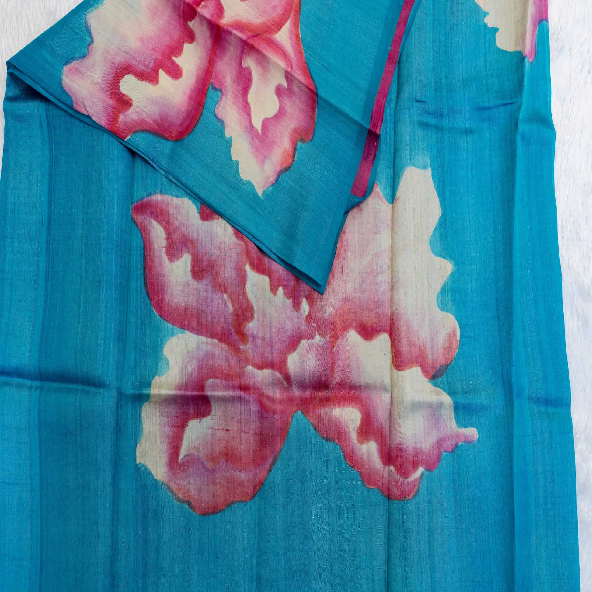 Blue fabric with pink floral patterns on a white background