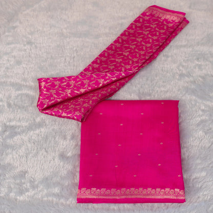 Pink saree with gold patterns on a gray background