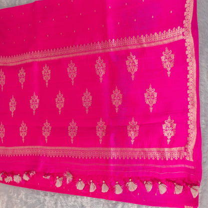 Pink saree with gold border and patterns on a gray background