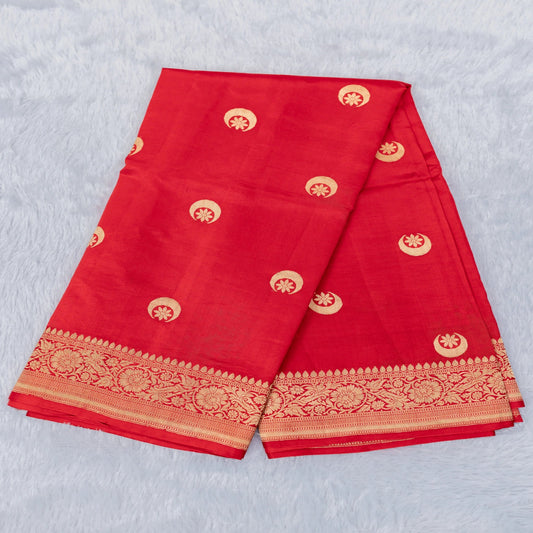 Red fabric with gold patterns on a light gray background