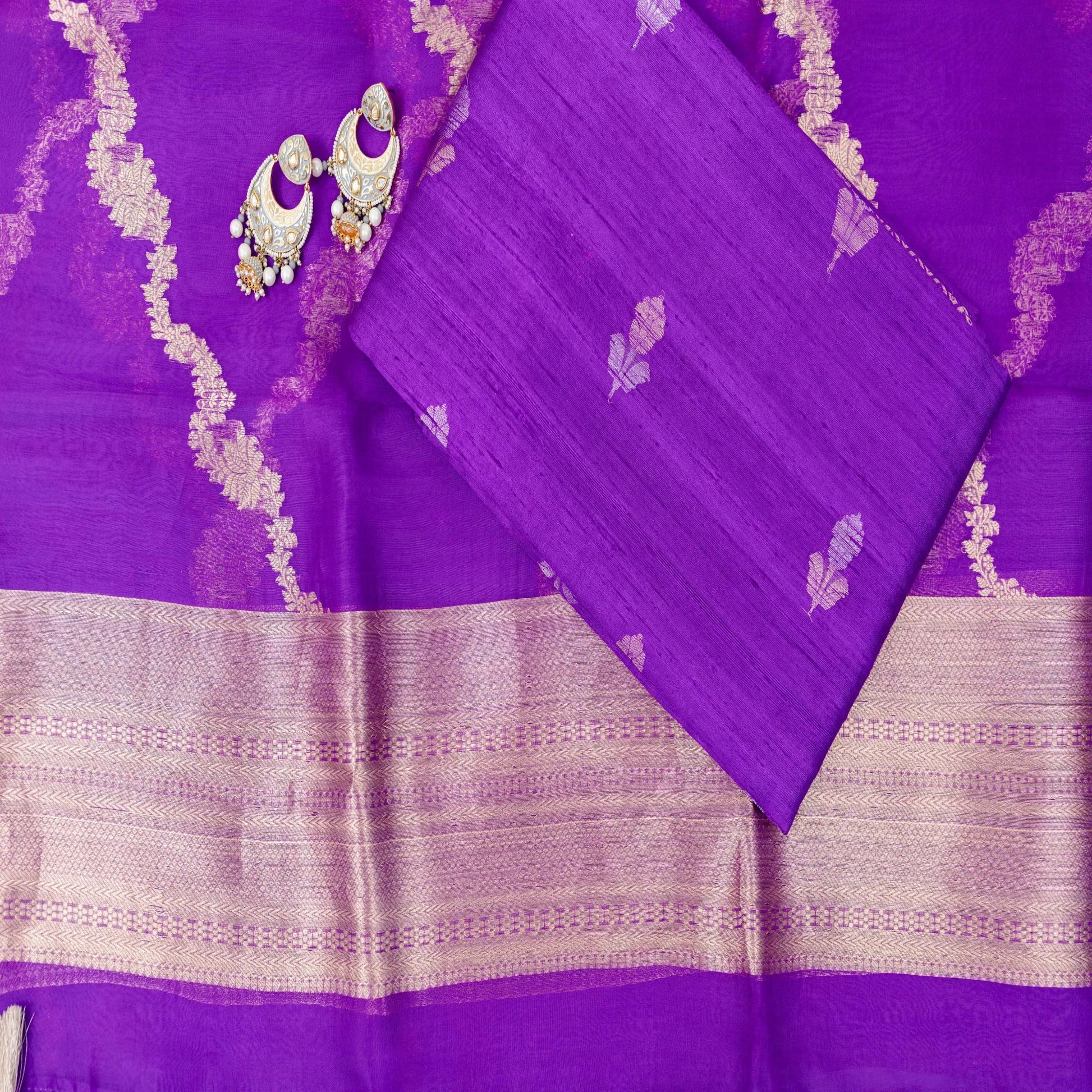 Purple fabric with white floral patterns and decorative elements