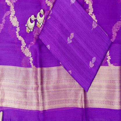 Purple fabric with white floral patterns and decorative elements