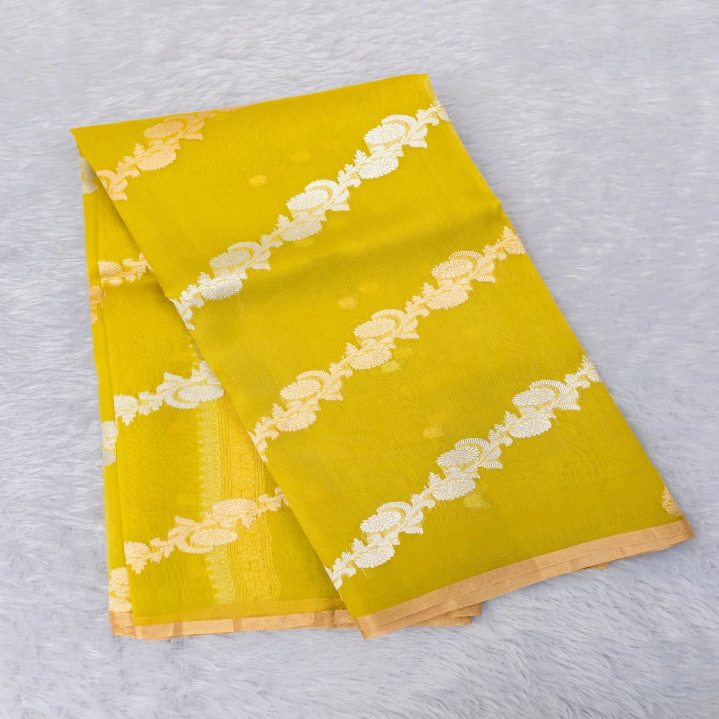 Two yellow napkins with white lace patterns on a light gray background