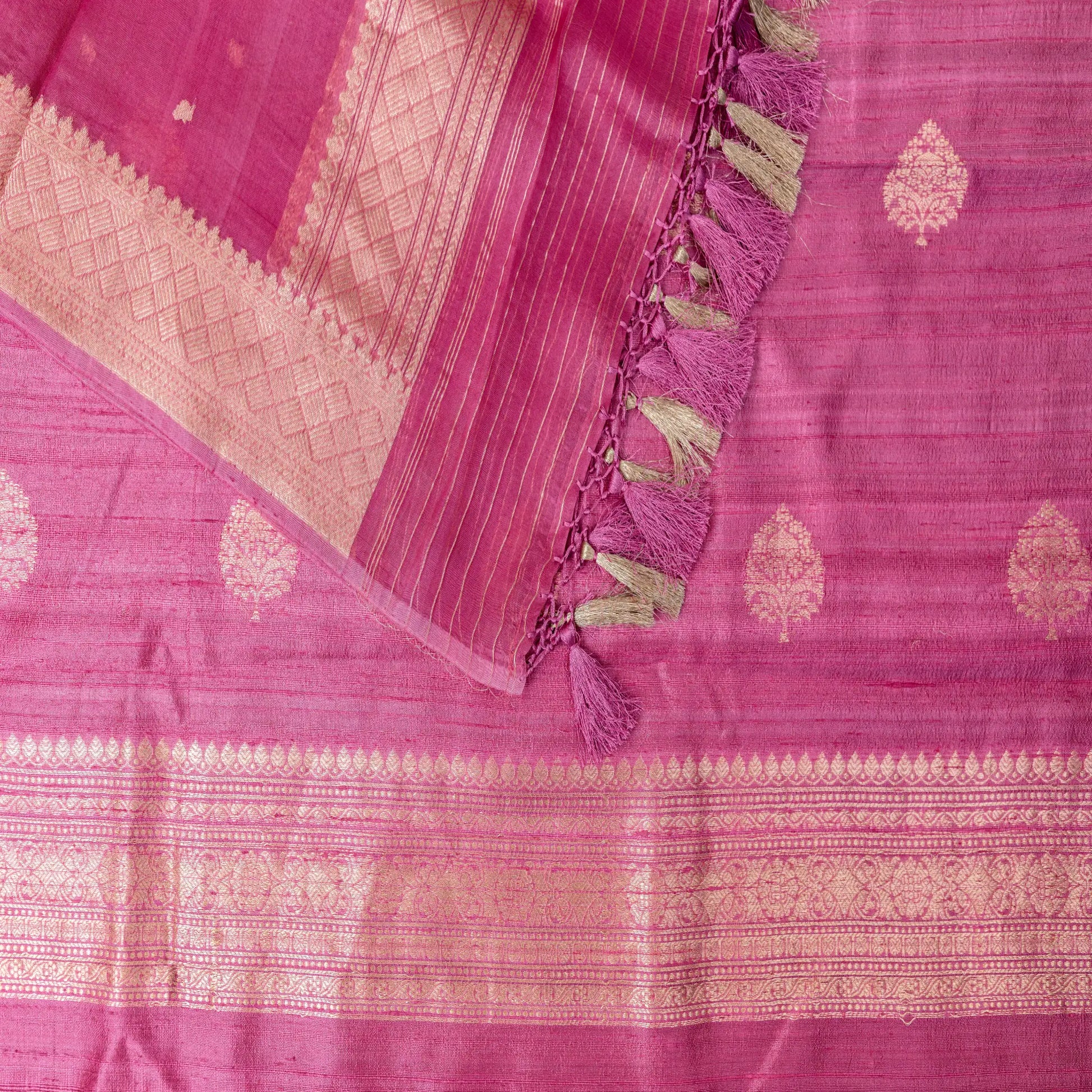 Pink saree with gold patterns and tassels