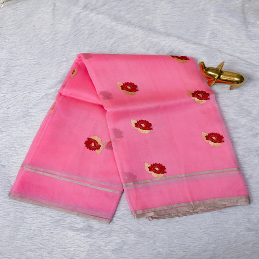 Pink saree with floral patterns on a light gray fabric background