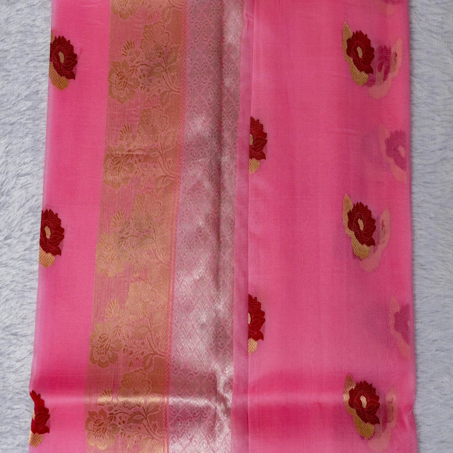 Pink saree with floral patterns on a white background